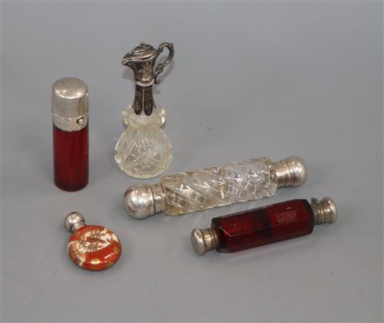 Two white metal mounted glass double ended scent bottles, a salts bottle, small ewer and silver mounted porcelain scent.